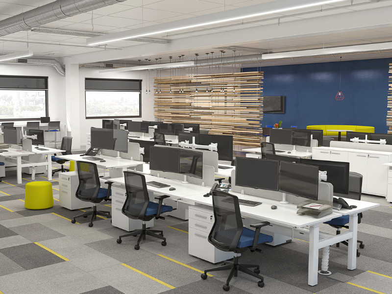 Agile white height adjustable desks in a large office layout